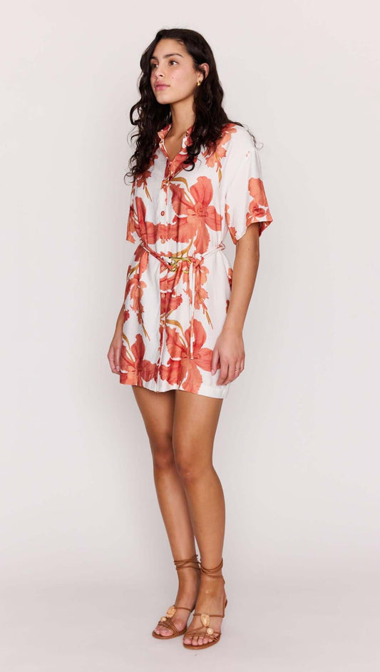 Model wearing a Peach Hibiscus Mini Shirt Dress with a relaxed silhouette and floral print.