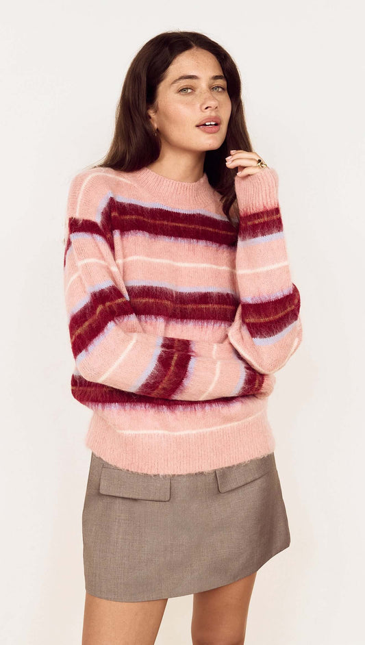 Model wearing a Pink Brushed Stripe Crew Neck Sweater styled with a mini skirt, showcasing cozy and vibrant hues.
