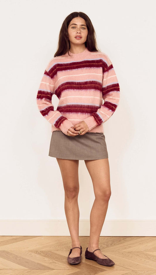 A model wearing the Pink Brushed Stripe Crew Neck Sweater over a mini skirt, highlighting its soft, trendy design.