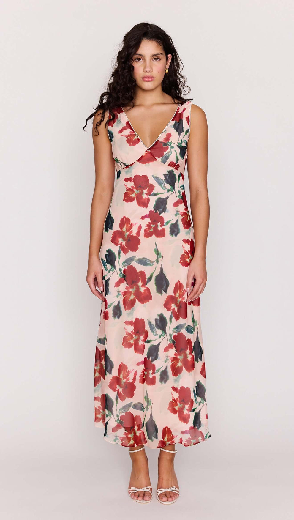 Model wearing a Pink Floral Bias Midi Dress featuring a deep V-neckline and vibrant floral print.
