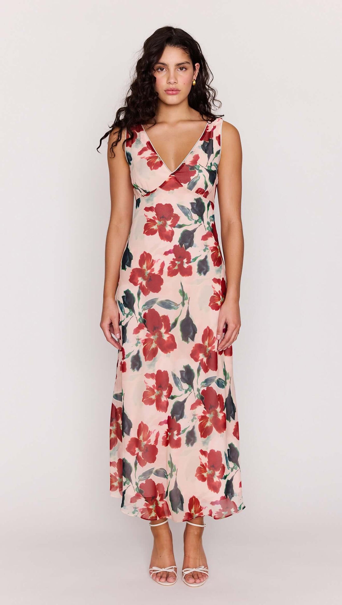 Model wearing a Pink Floral Bias Midi Dress featuring a deep V-neckline and vibrant floral print.