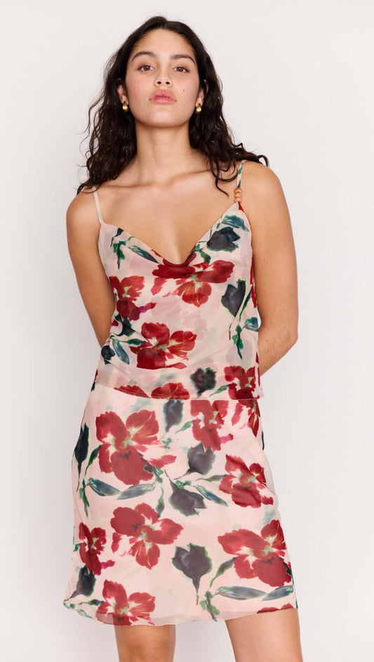 Model wearing a Pink Floral Bias Slip Skirt with a mesh floral top, showcasing a floral print and elegant silhouette.