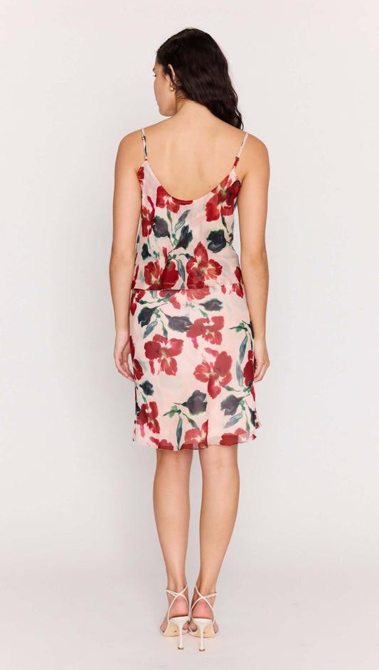 Back view of a model wearing the Pink Floral Bias Slip Skirt featuring a soft floral design and fluid silhouette.