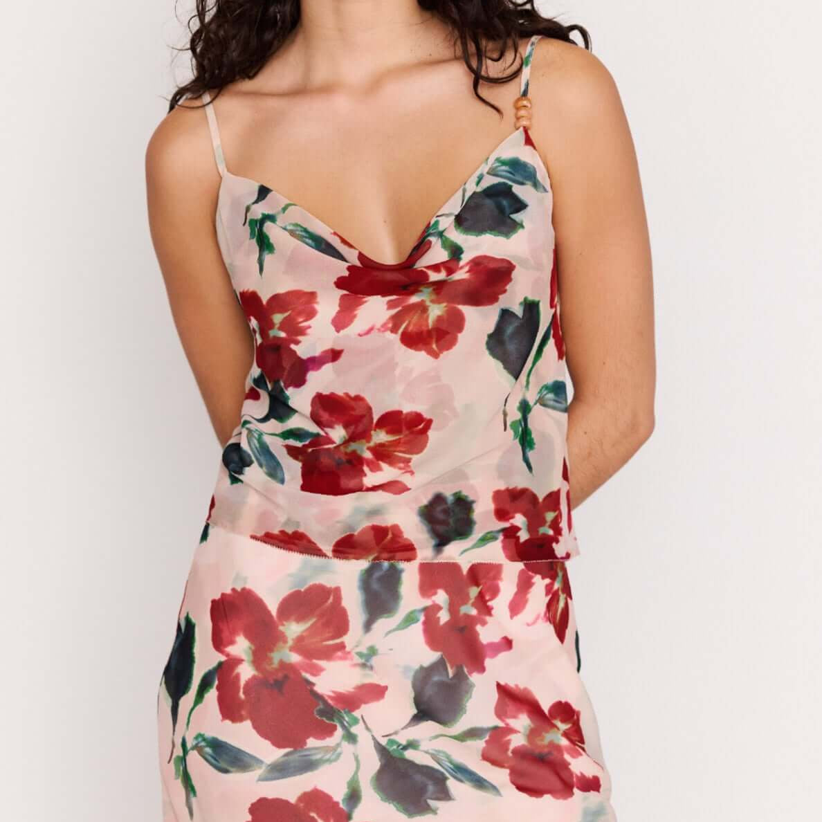 Pink Floral Cowl Neck Cami Top modeled by a model with a floral print on a soft background.