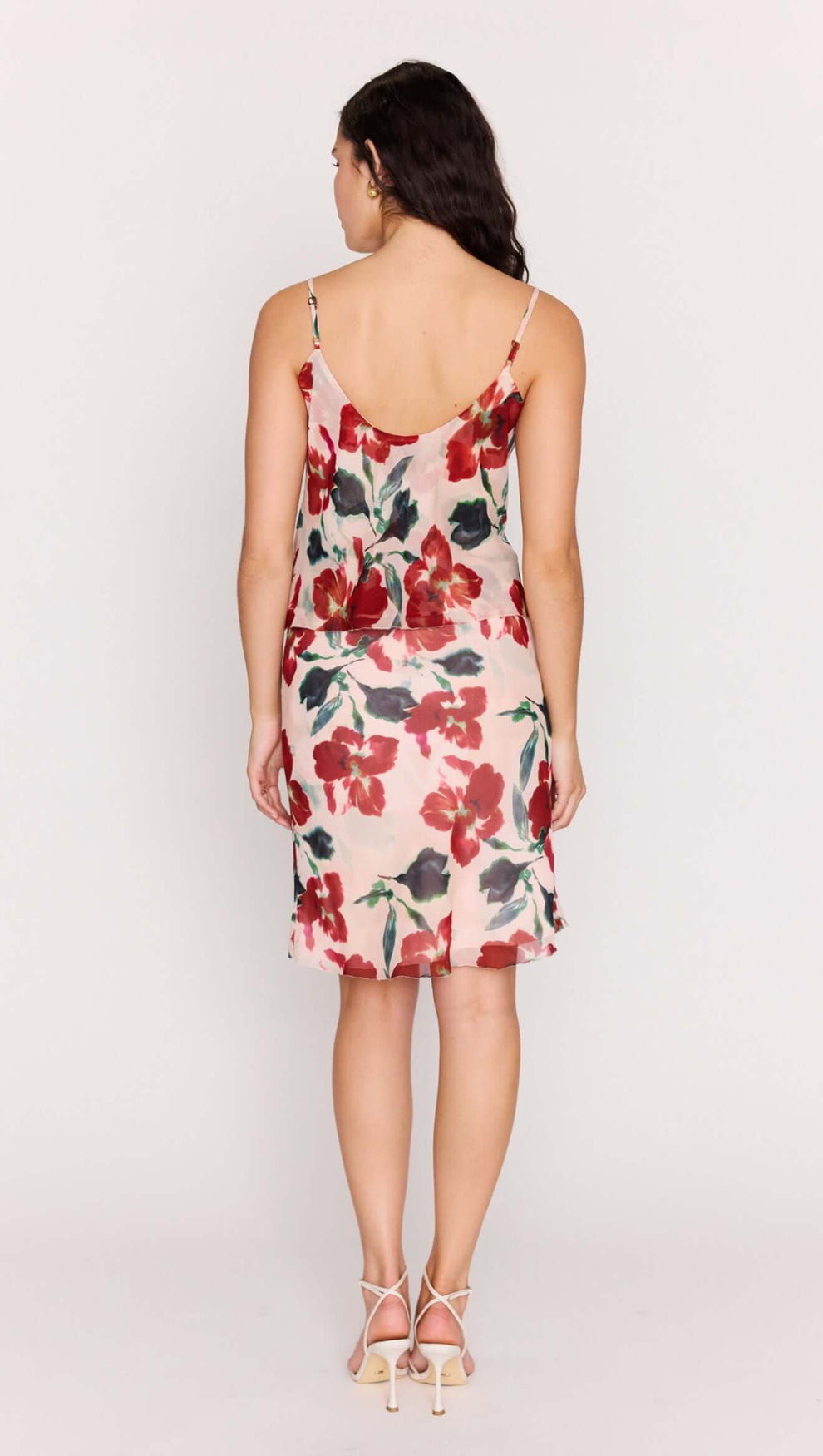 Back view of a model wearing the Pink Floral Cowl Neck Cami Top with a soft floral print.