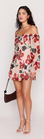 Model wearing a Pink Floral Off Shoulder Dress featuring a floral print and relaxed mini silhouette.