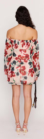 Back view of a woman wearing a Pink Floral Off Shoulder Dress with long sleeves and floral pattern.