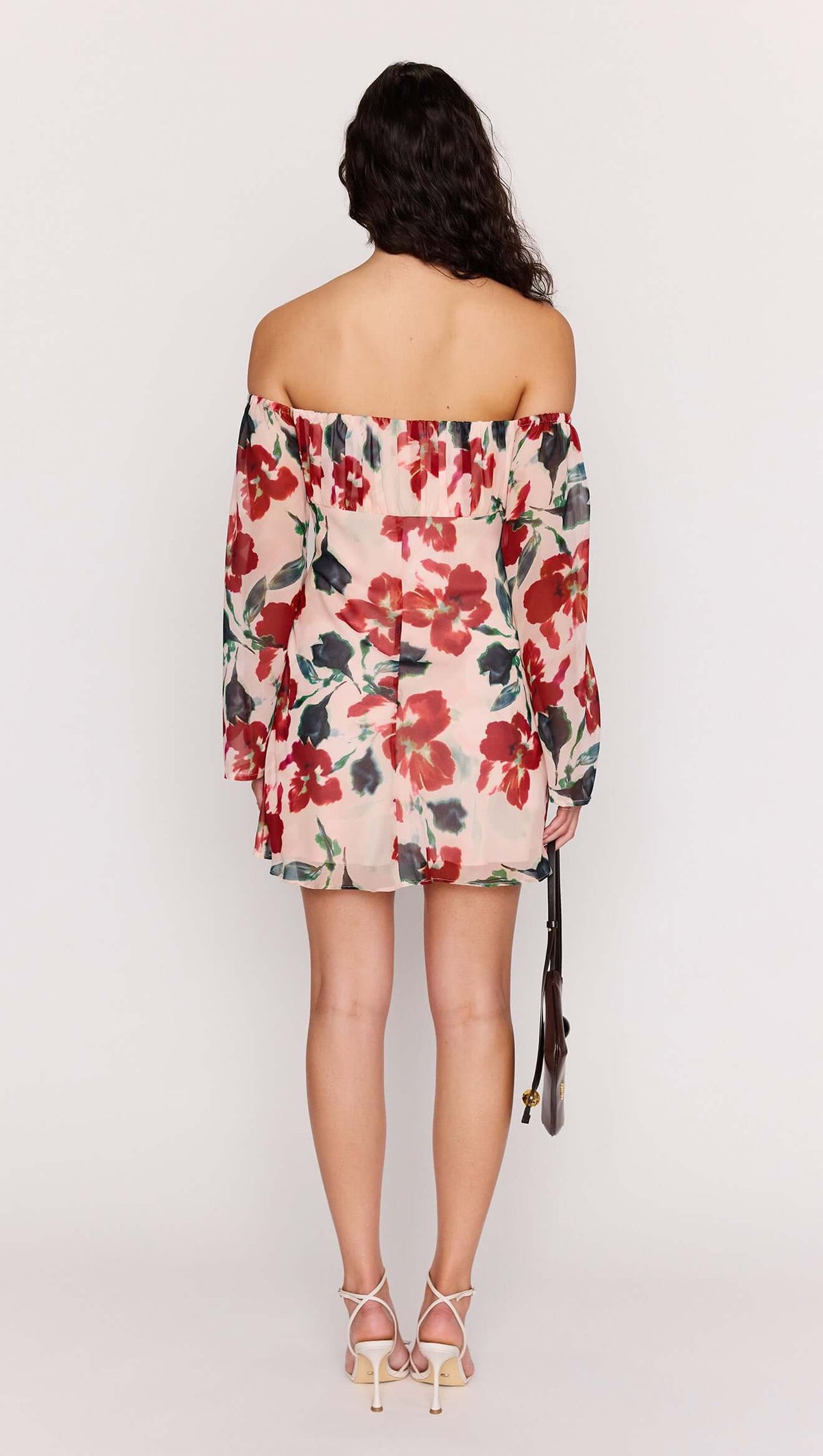 Back view of a woman wearing a Pink Floral Off Shoulder Dress with long sleeves and floral pattern.