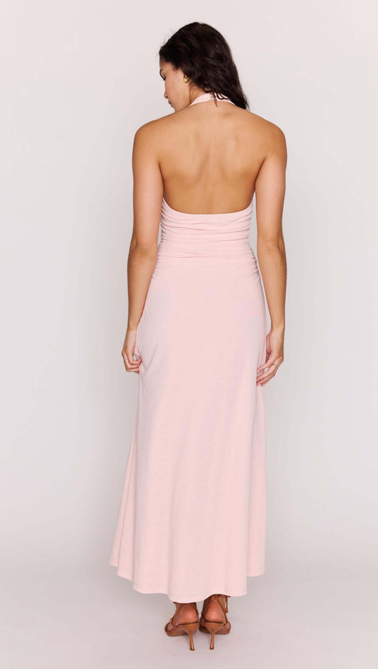 Back view of a model wearing the Pink Halter Neck Ruched Midi Dress in soft pink, showcasing its elegant design.