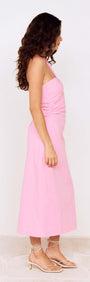 Model wearing a Pink Keyhole Detail Halter Neck Midi Dress, showcasing its elegant side profile and flowing design.