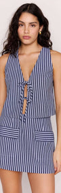 Model wearing a Pinstripe Tie Front Vest Top with adjustable ties and matching skirt in a stylish coastal look.