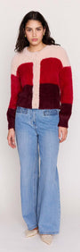 A model wearing a Red Colour Block Fluffy Cardigan with soft texture, paired with light blue jeans.