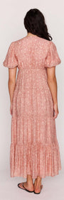 Back view of Red Floral Puff Sleeve Maxi Dress showcasing soft puff sleeves and tiered skirt design.