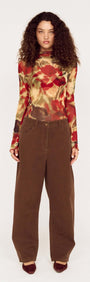 Red Floral Sheer Mesh High Neck Top styled with brown wide-leg pants, showcasing an elegant and casual look.