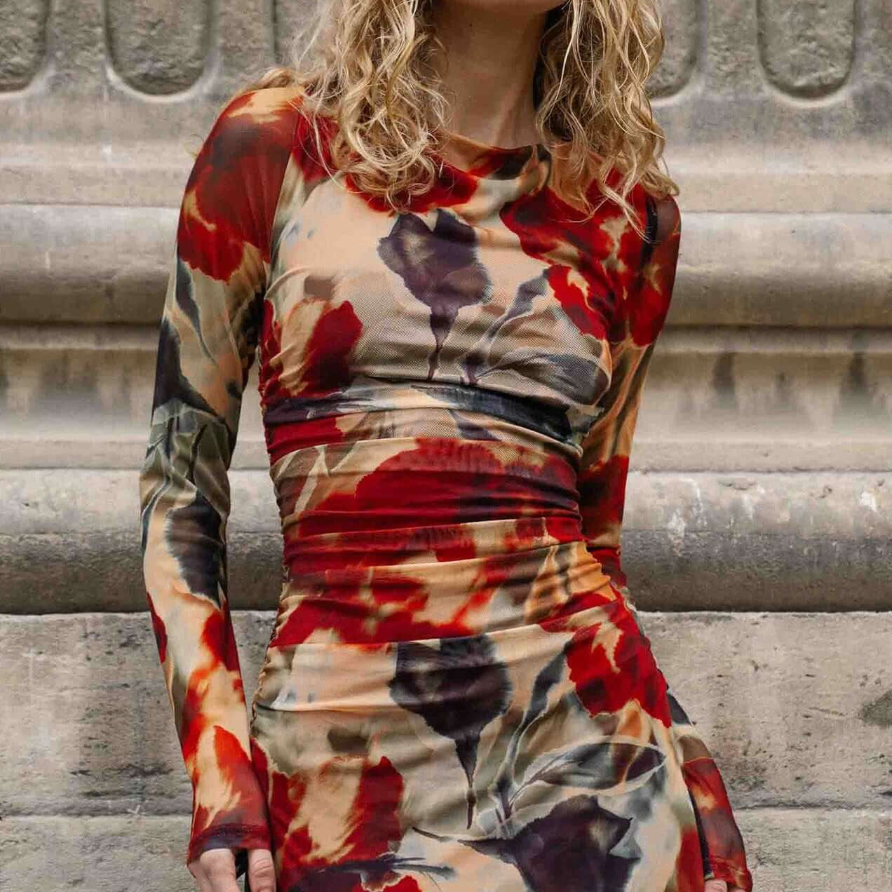 Red Floral Sheer Mesh Midi Dress featuring a model with sunglasses standing against a textured stone background.