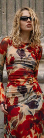 Red Floral Sheer Mesh Midi Dress featuring a model with sunglasses standing against a textured stone background.