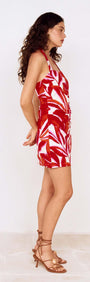 Red Palm Print Halter Neck Mini Dress featuring a model in profile view, showcasing its vibrant design and flattering fit.