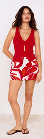 Model wearing a Red Palm Print Mini Skirt paired with a red top, showcasing a stylish warm-weather outfit.