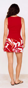BACK VIEW OF A WOMAN WEARING A RED PALM PRINT MINI SKIRT WITH A SOLID RED TOP, SHOWCASING A BOLD WARM-WEATHER STYLE.