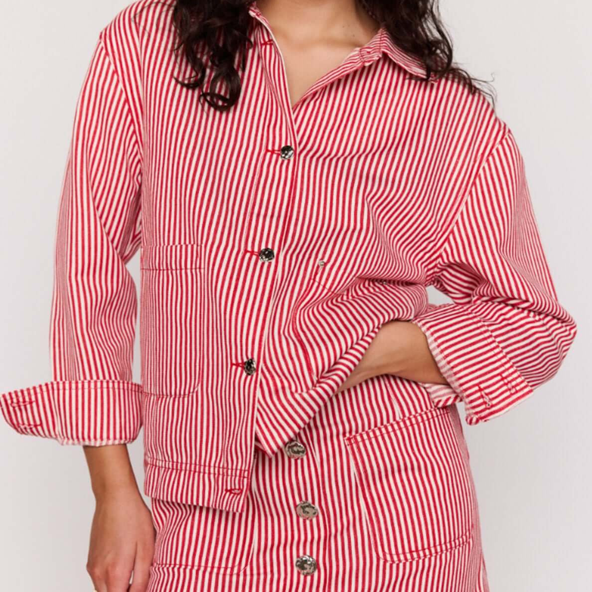 Red Pinstriped Denim Jacket styled with matching skirt, featuring vertical stripes and relaxed fit for effortless fashion.