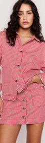 Red Pinstriped Denim Jacket styled with matching skirt, featuring vertical stripes and relaxed fit for effortless fashion.