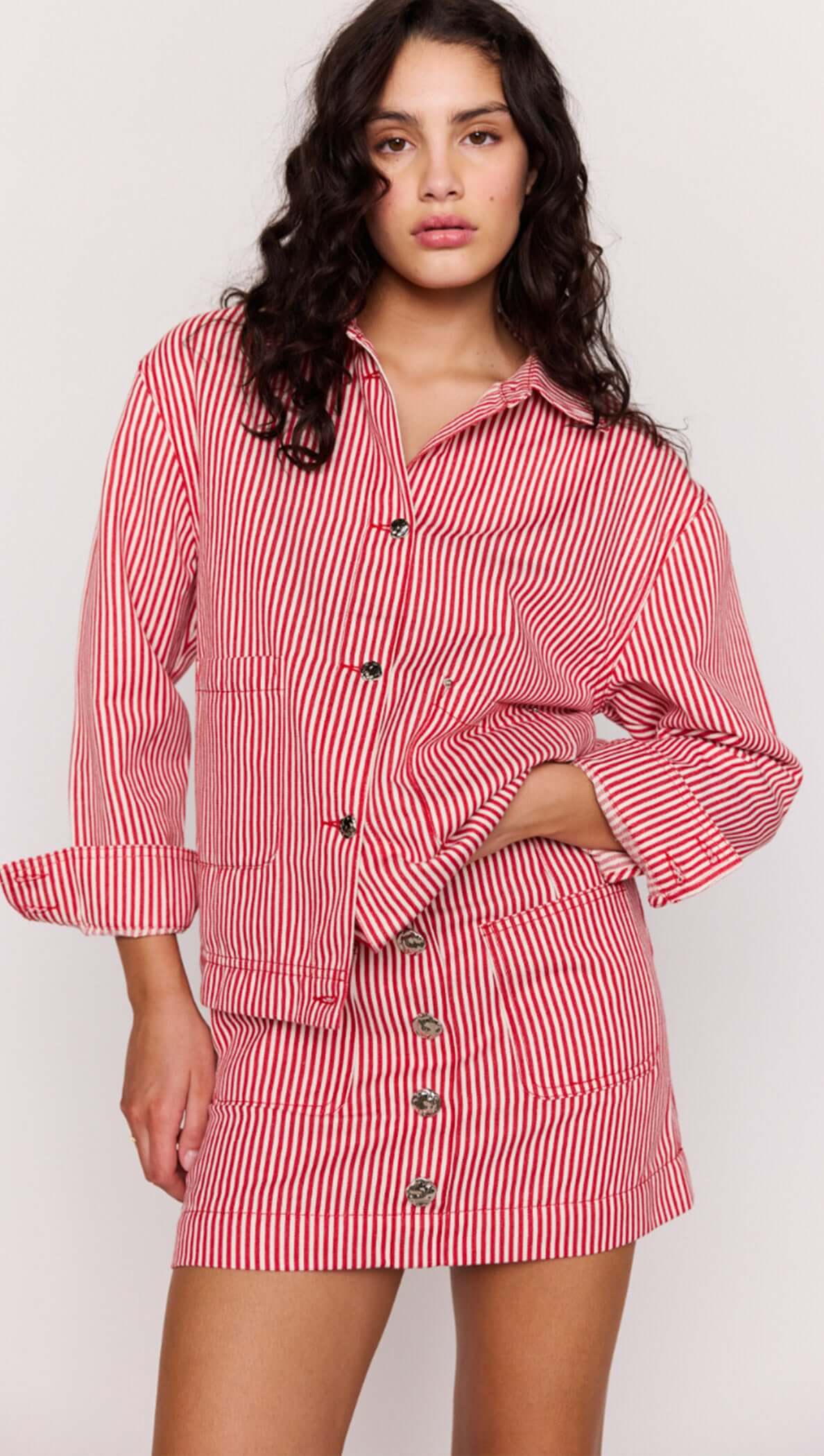 Red Pinstriped Denim Jacket styled with matching skirt, featuring vertical stripes and relaxed fit for effortless fashion.
