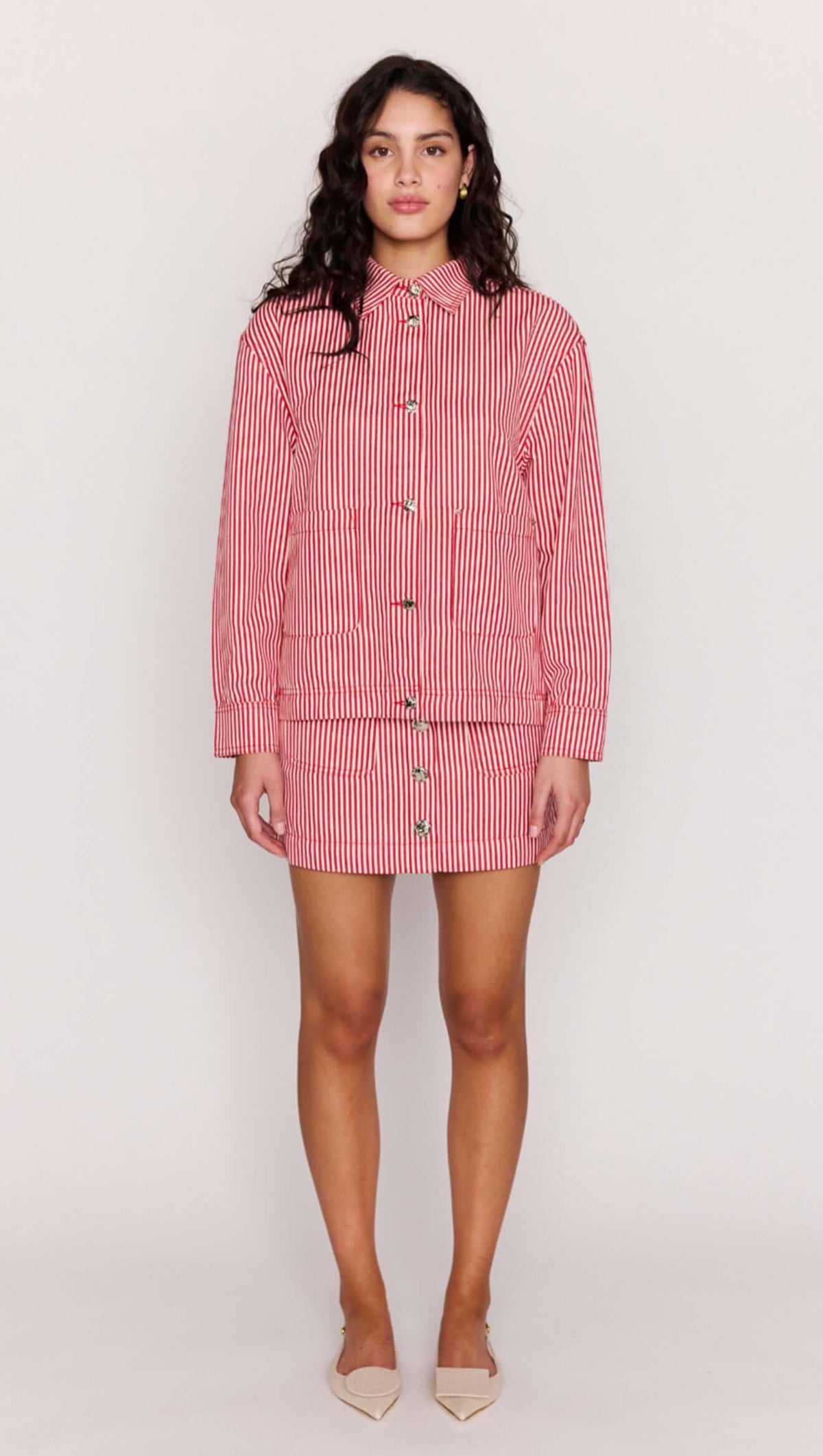 Model wearing a Red Pinstriped Denim Jacket styled with a matching mini skirt.