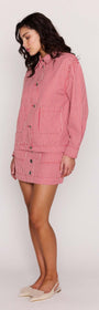 Red Pinstriped Denim Jacket styled with matching mini skirt, showcasing relaxed fit and vertical red and white stripes.