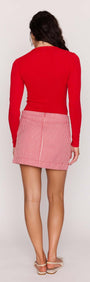 Back view of a model wearing the Red Pinstriped Denim Mini Skirt paired with a fitted red top.