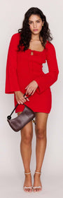 Model wearing the Red Ribbed Knit Mini Dress featuring a square neckline and tie-front detail.