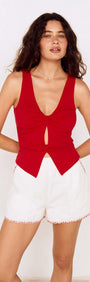 Model wearing a Red Twist Front Jersey Top paired with white shorts, showcasing a stylish summer outfit.