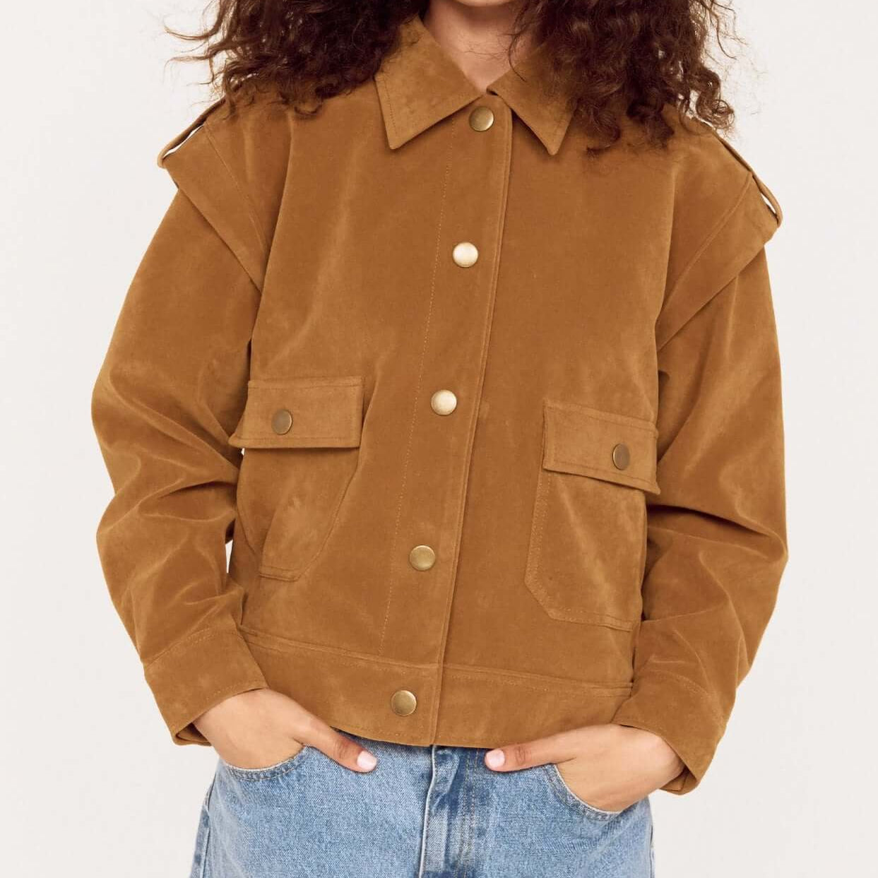 Model wearing a Relaxed Fit Faux Suede Jacket in brown with large pockets and a collared neckline, paired with blue jeans.
