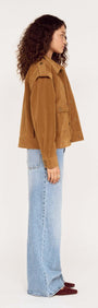 Side view of a model wearing a Relaxed Fit Faux Suede Jacket with light blue jeans against a neutral background.