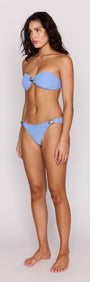 Model wearing the Sky Blue Shell Twist Bandeau Bikini Top with matching bikini bottom, highlighting a stylish beach look.