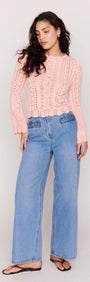 Soft Pink Cotton Pointelle Cardigan styled with high-waisted blue jeans and sandals on a model.