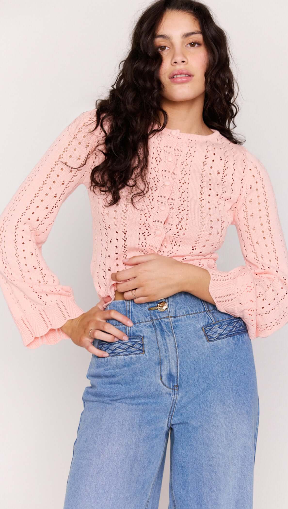 Soft Pink Cotton Pointelle Cardigan featuring pointelle knit and button-through front, styled with high-waisted jeans.