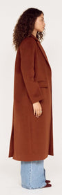Model showcasing the Soft Touch Tailored Coat in Chocolate from the side, featuring a chic design and elegant silhouette.