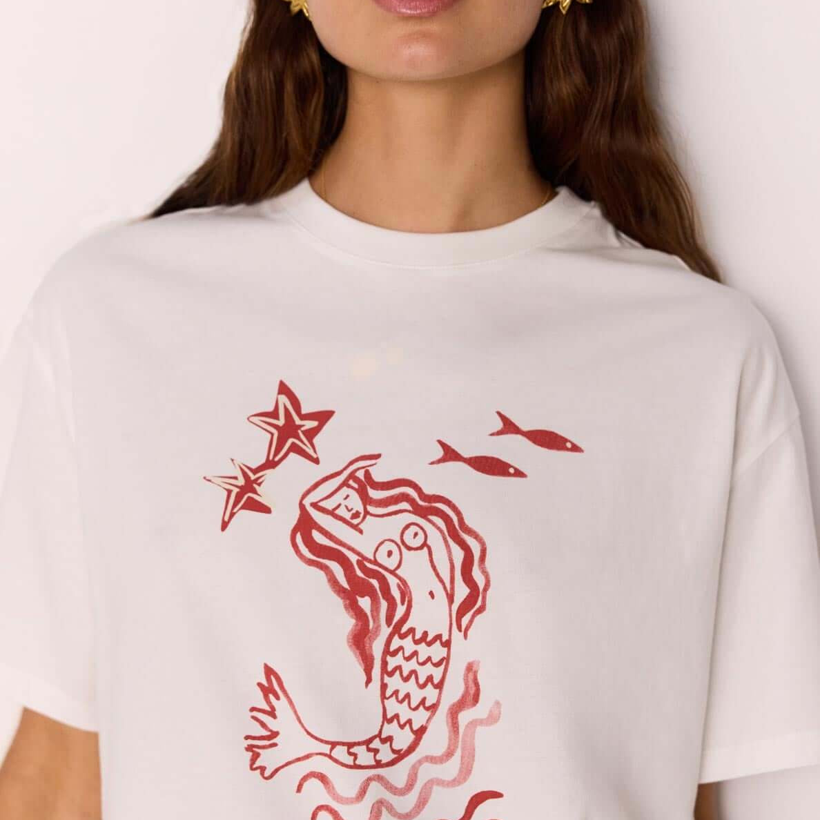 Cotton Mermaid Print T-Shirt featuring an exclusive mermaid artwork print in a relaxed fit and one-shoulder design.