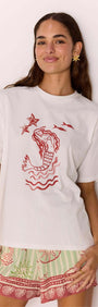 Woman wearing a Cotton Mermaid Print T-Shirt with exclusive mermaid artwork, perfect for summer vibes.