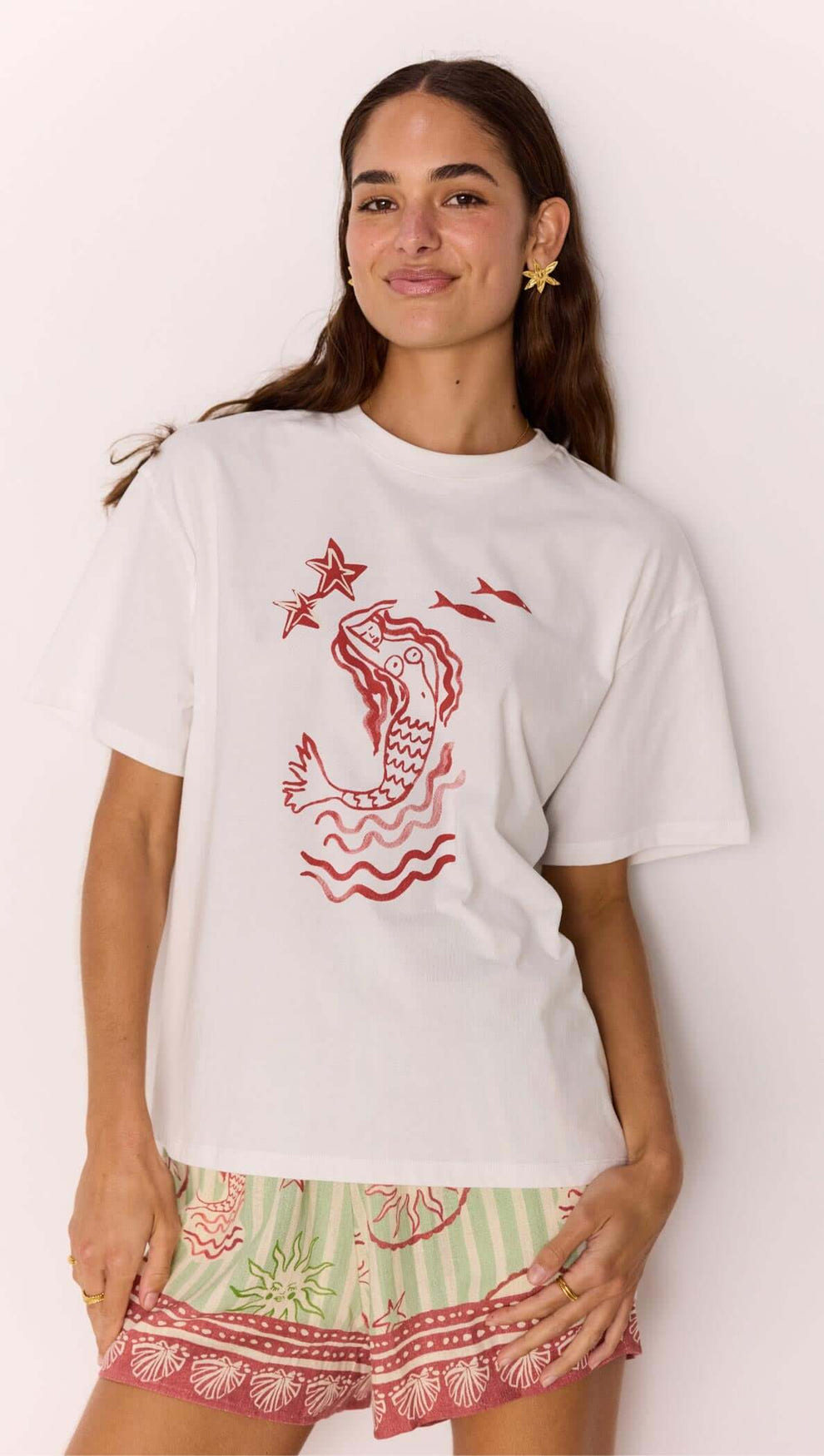 Woman wearing a Cotton Mermaid Print T-Shirt with exclusive mermaid artwork, perfect for summer vibes.