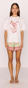 Model wearing a Cotton Mermaid Print T-Shirt with mermaid graphic paired with colorful shorts.