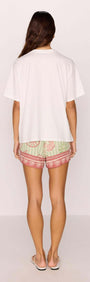 Back view of a model wearing a Cotton Mermaid Print T-Shirt with patterned shorts.