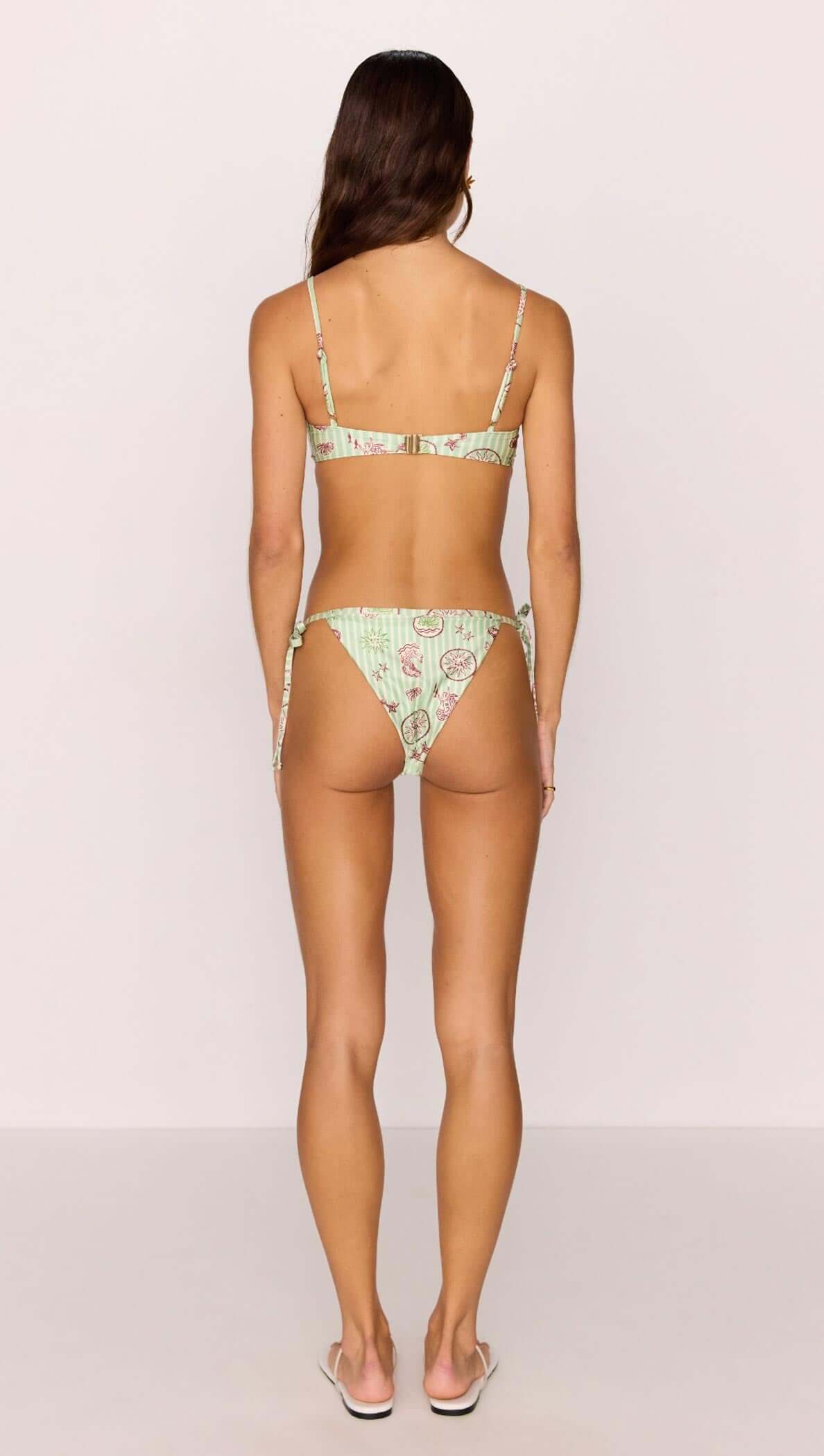 Back view of a model wearing the Green Stripe Printed Bikini Bra Top, showcasing its unique design and fit.