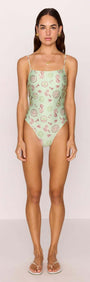 Green Stripe Printed Low-Back One Piece Swimsuit on a model showcasing the exclusive shell and sea motif.