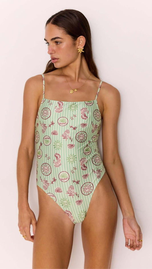 Model wearing Green Stripe Printed Low-Back One Piece Swimsuit showcasing vintage shell and sea motifs.