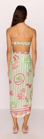 Back view of a woman wearing a Green Stripe Printed Sarong styled as a beach wrap.