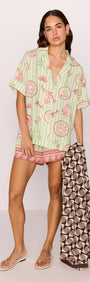 Model wearing Linen Blend Green Stripe Printed Shirt with tropical print, perfect for summer and beach days.