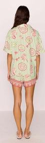 Linen Blend Green Stripe Printed Shorts worn with a matching shirt, showcasing a vibrant summer outfit from the back.