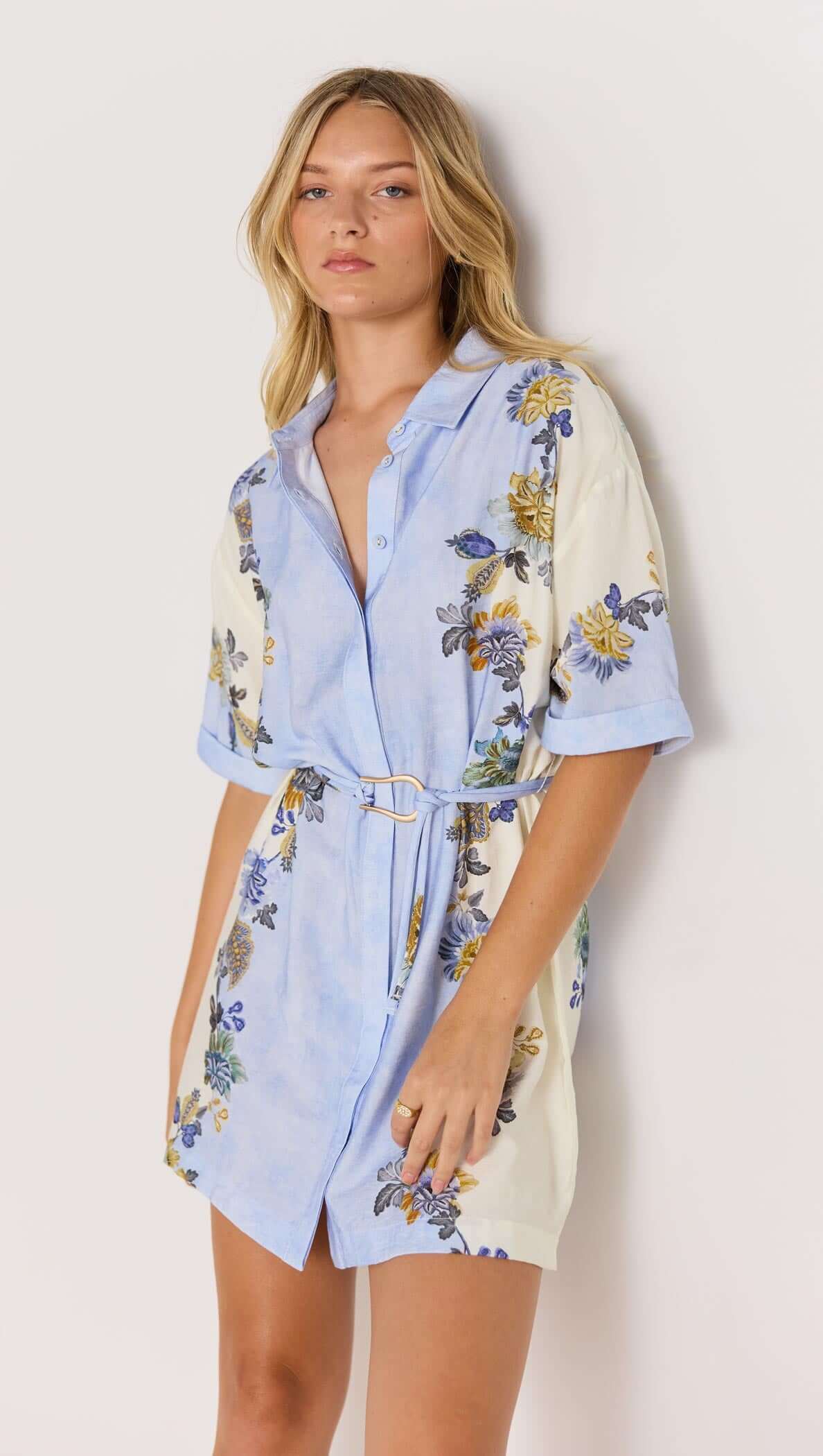 Lucia blue floral mini shirtdress with tie waist, featuring a relaxed fit and rolled short sleeves.