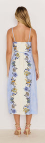 Back view of Lucia blue floral midi dress with tie waist, featuring a flowing skirt and vibrant floral prints.